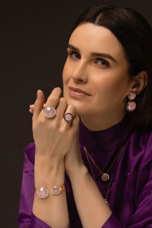 O Anel Único - Quartzo Rosa faz parte da Coleção Singular, que celebra a beleza e a nobreza de uma mulher. Este anel é a expressão do simples em sua forma mais magnífica, apresentando o Quartzo Rosa, a pedra do amor incondicional. Banhado a Ouro 18K, ele promove paz interior, afeto e a manifestação do amor em todas as suas formas, sendo uma peça marcante que aflora a imponência feminina em sua essência.